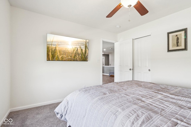 bedroom featuring a closet, baseboards, a ceiling fan, and carpet