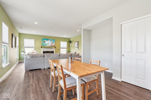 dining area with recessed lighting, a fireplace, dark wood-type flooring, and baseboards
