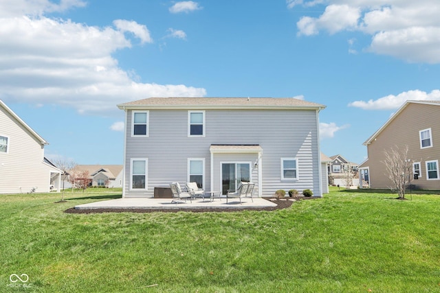 rear view of house with a patio area and a lawn