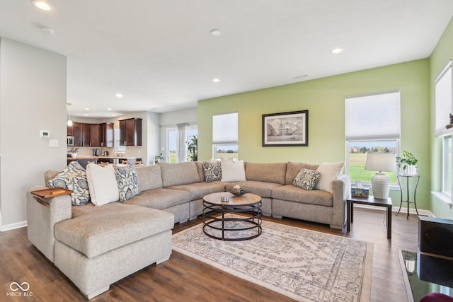 living room with baseboards, recessed lighting, and dark wood-style floors