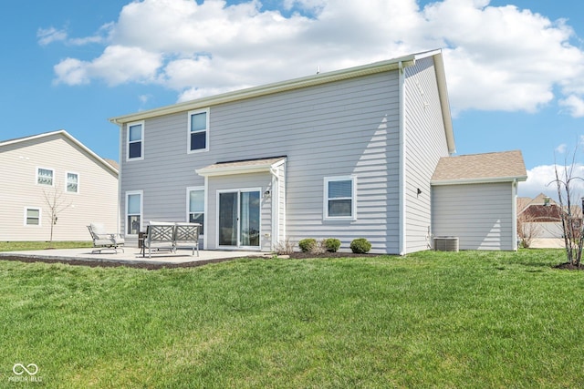 rear view of house featuring a yard and a patio area