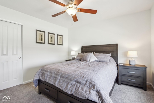 carpeted bedroom featuring baseboards and a ceiling fan