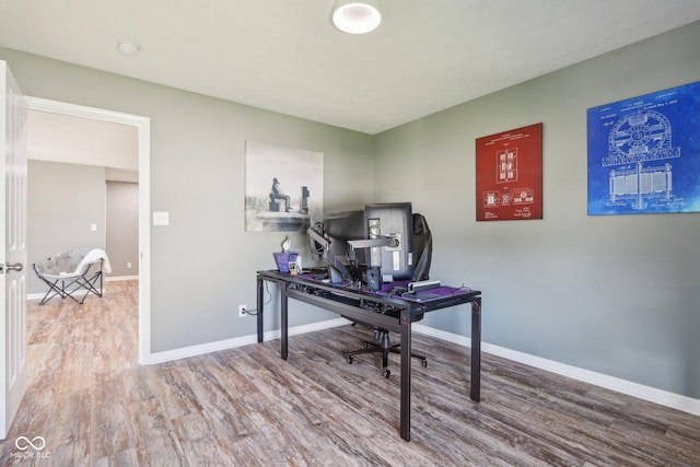 office featuring baseboards and wood finished floors