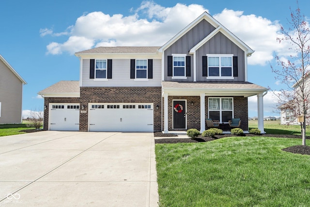 craftsman house featuring a front yard, covered porch, board and batten siding, brick siding, and driveway