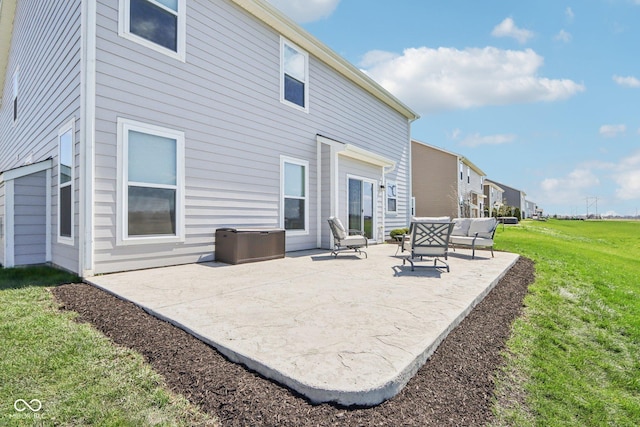 back of property with a yard and a patio area