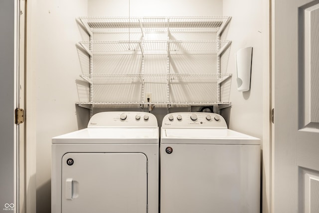 laundry room featuring separate washer and dryer and laundry area