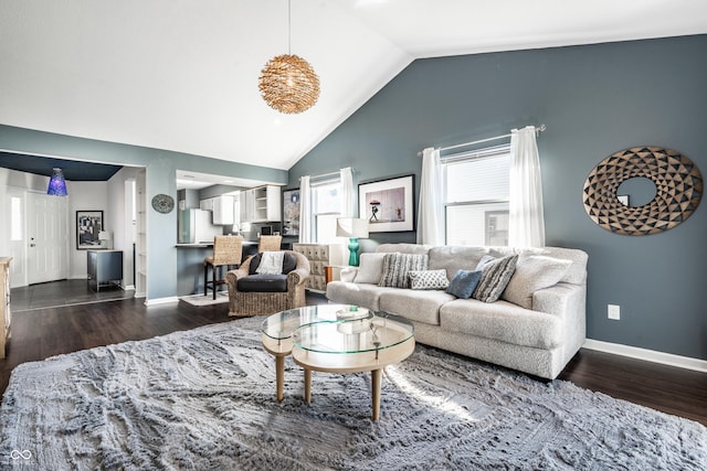 living area with baseboards, dark wood-style floors, and high vaulted ceiling