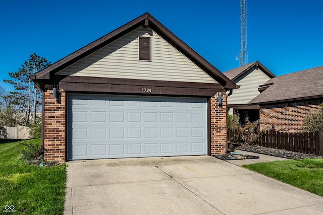 garage featuring fence and concrete driveway