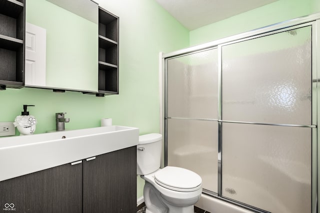 full bathroom with toilet, a shower stall, and vanity