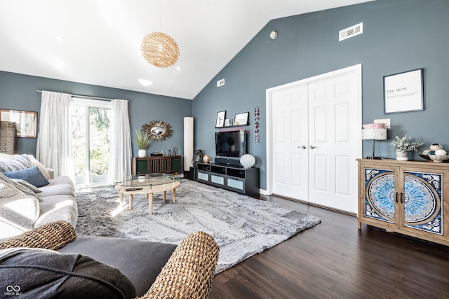 living area featuring high vaulted ceiling, visible vents, and wood finished floors