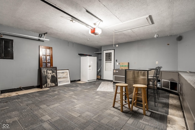 interior space featuring a garage door opener, electric panel, and white refrigerator with ice dispenser