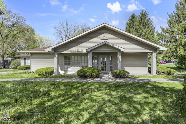 single story home with a front lawn and a porch