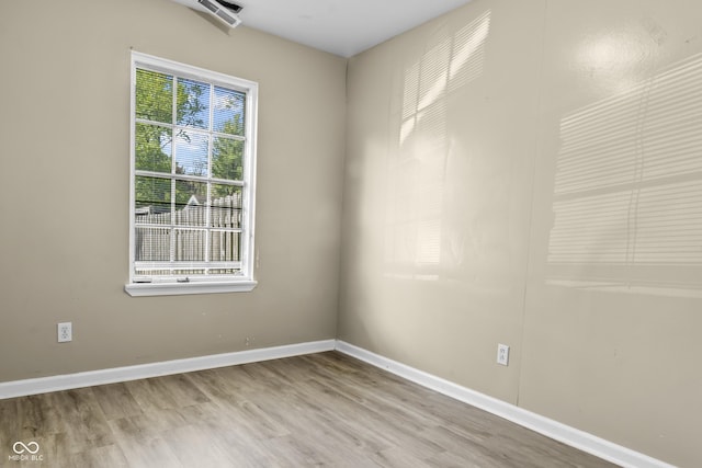 empty room featuring baseboards and wood finished floors