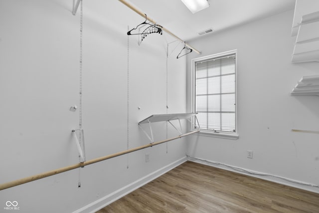 walk in closet with visible vents and wood finished floors