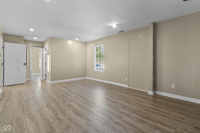 unfurnished room featuring recessed lighting, baseboards, and wood finished floors