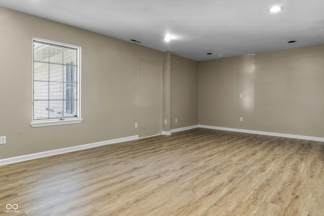 unfurnished room with baseboards, visible vents, recessed lighting, and wood finished floors