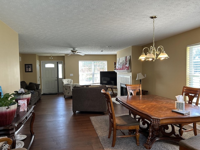 804 Seabreeze Dr, Avon, IN 46123 - dining room with dark wood-style floors, a textured ceiling, a chandelier, and ceiling fan