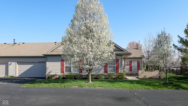 7971 Cool Hollow Pl, Indianapolis, IN 46237 - view of property hidden behind natural elements featuring an attached garage, a front yard, fence, and driveway