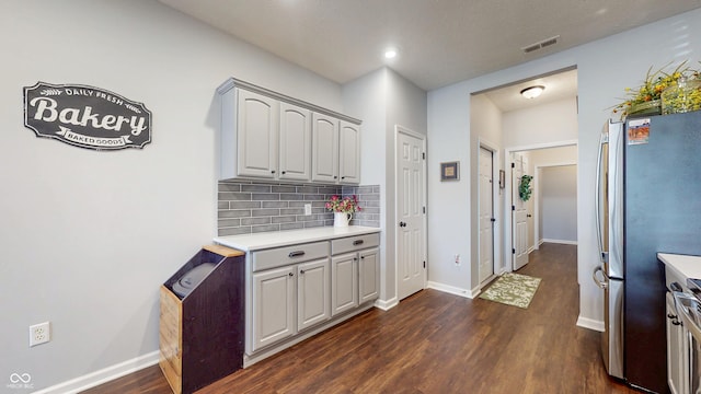 7971 Cool Hollow Pl, Indianapolis, IN 46237 - kitchen featuring dark wood-style floors, freestanding refrigerator, visible vents, decorative backsplash, and light countertops