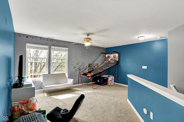 recreation room with carpet floors, baseboards, and ceiling fan