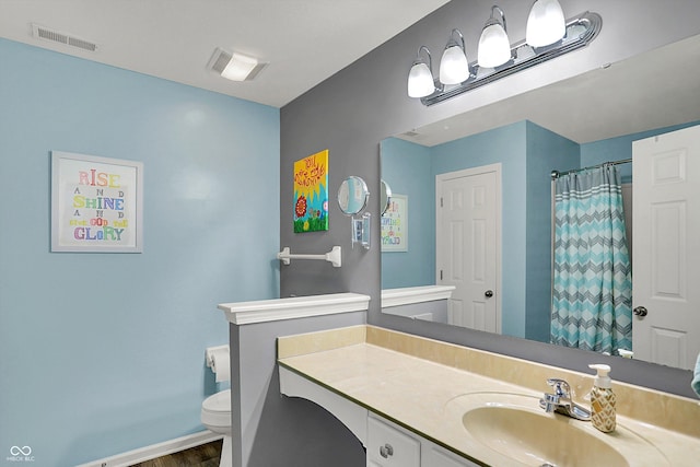 full bath with toilet, baseboards, visible vents, wood finished floors, and vanity