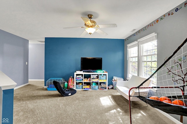 recreation room with ceiling fan, baseboards, carpet flooring, and visible vents