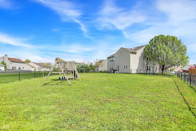 view of yard featuring fence and a playground