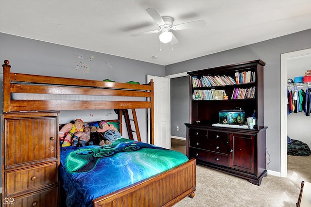 carpeted bedroom with a ceiling fan and baseboards