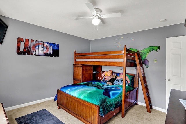 carpeted bedroom featuring baseboards and ceiling fan