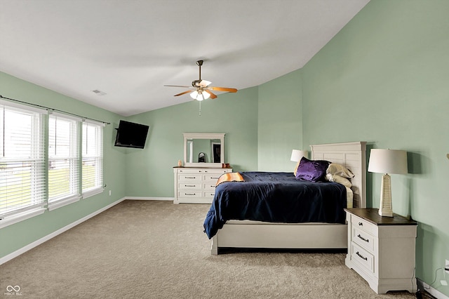 bedroom featuring lofted ceiling, visible vents, a ceiling fan, light carpet, and baseboards