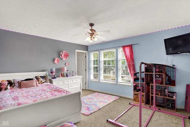 carpeted bedroom featuring baseboards and a ceiling fan