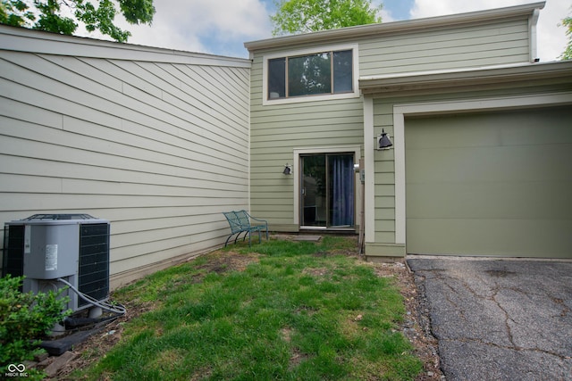 entrance to property with central AC and aphalt driveway