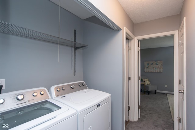 laundry room with washing machine and clothes dryer, a textured ceiling, laundry area, and carpet floors