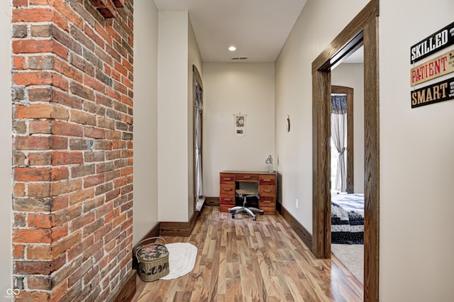 3864 N US Highway 231, Greencastle, IN 46135 - corridor with brick wall, light wood-style floors, baseboards, and visible vents