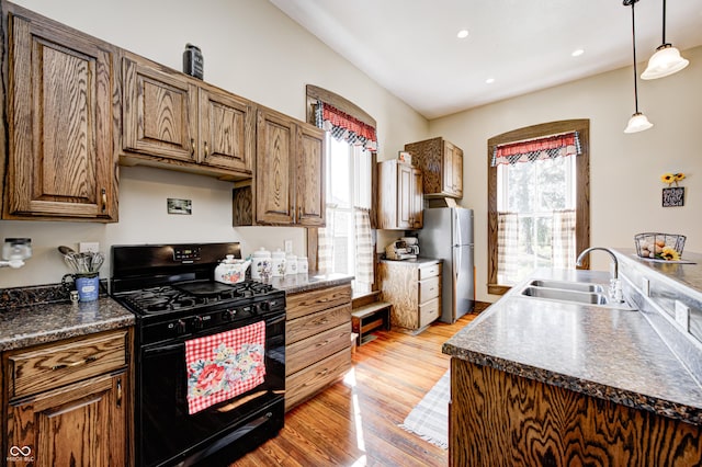 3864 N US Highway 231, Greencastle, IN 46135 - kitchen featuring a sink, freestanding refrigerator, dark countertops, light wood-style floors, and gas stove