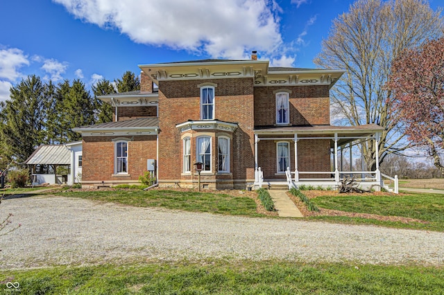 3864 N US Highway 231, Greencastle, IN 46135 - italianate home featuring brick siding, a porch, metal roof, and a standing seam roof