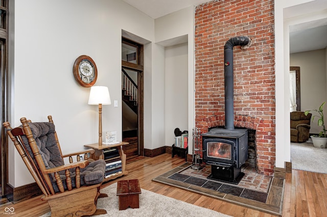 3864 N US Highway 231, Greencastle, IN 46135 - living room with a wood stove, baseboards, stairway, and hardwood / wood-style flooring