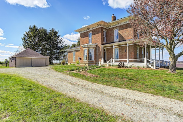 3864 N US Highway 231, Greencastle, IN 46135 - italianate home featuring a detached garage, covered porch, an outdoor structure, brick siding, and a front lawn