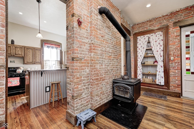 3864 N US Highway 231, Greencastle, IN 46135 - interior space featuring hardwood / wood-style floors, brick wall, a wood stove, and recessed lighting