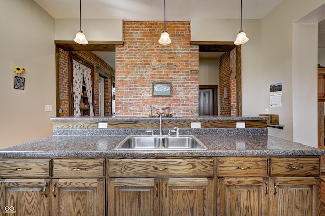 3864 N US Highway 231, Greencastle, IN 46135 - kitchen featuring brick wall, pendant lighting, a sink, and dark stone counters