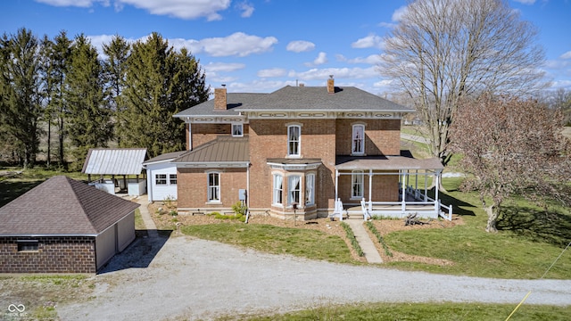 3864 N US Highway 231, Greencastle, IN 46135 - view of front facade featuring a chimney, a front yard, dirt driveway, and brick siding