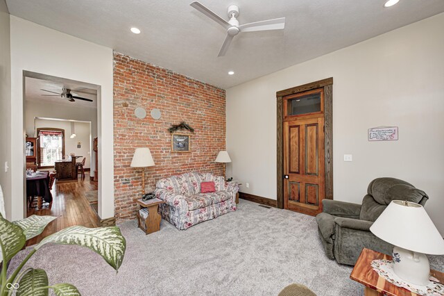 3864 N US Highway 231, Greencastle, IN 46135 - carpeted living room featuring brick wall, ceiling fan, and recessed lighting