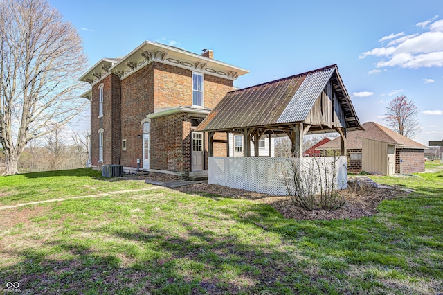 3864 N US Highway 231, Greencastle, IN 46135 - back of house with cooling unit, a yard, a chimney, and brick siding