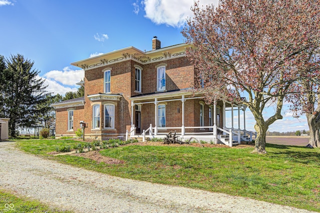 3864 N US Highway 231, Greencastle, IN 46135 - italianate house with brick siding, a porch, a chimney, and a front lawn