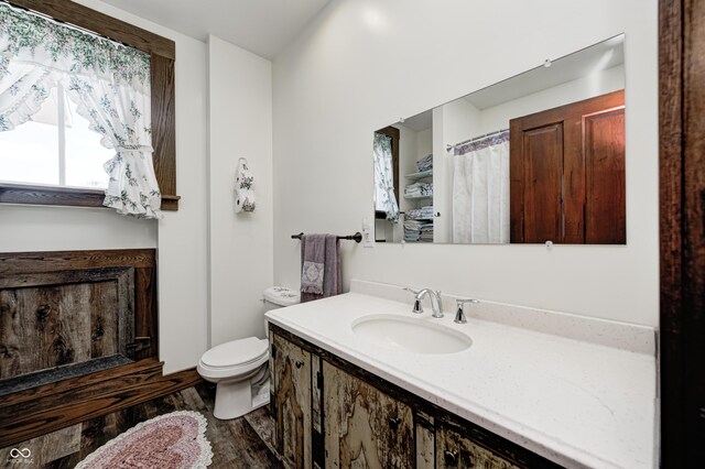 3864 N US Highway 231, Greencastle, IN 46135 - bathroom featuring toilet, vanity, and wood finished floors