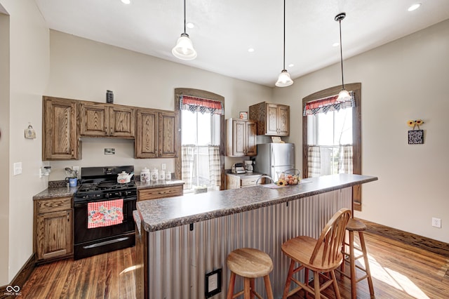 3864 N US Highway 231, Greencastle, IN 46135 - kitchen featuring dark countertops, black range with gas cooktop, freestanding refrigerator, and dark wood-style floors