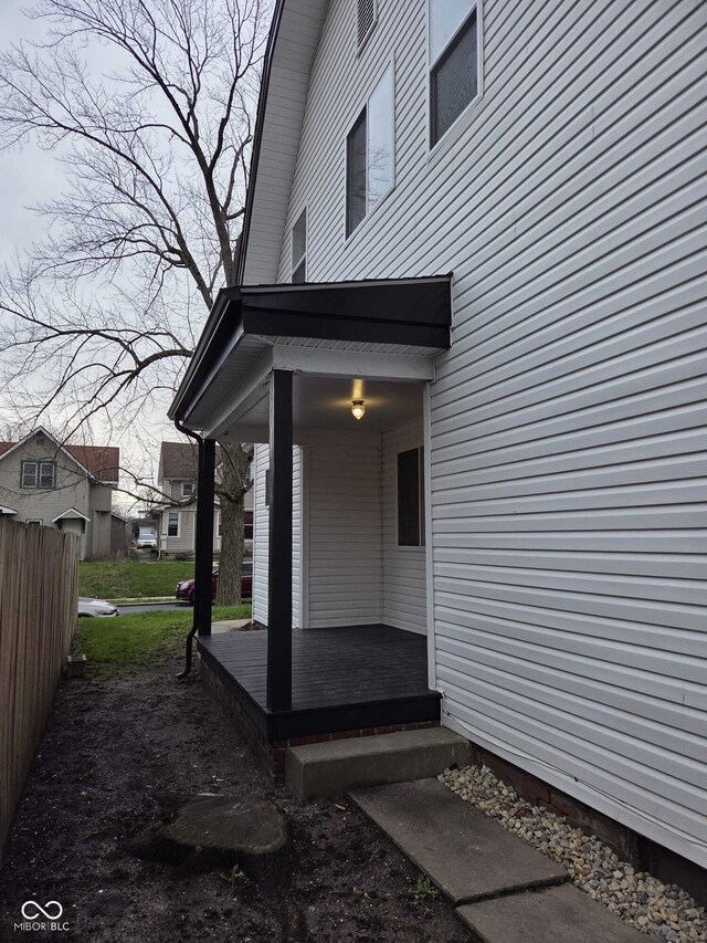 doorway to property featuring fence