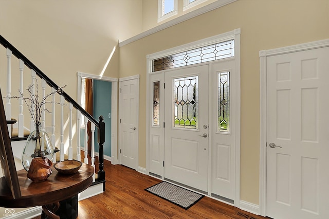 4932 Willow Ridge Ct, Zionsville, IN 46077 - foyer entrance with stairway, baseboards, a high ceiling, and dark wood-style floors