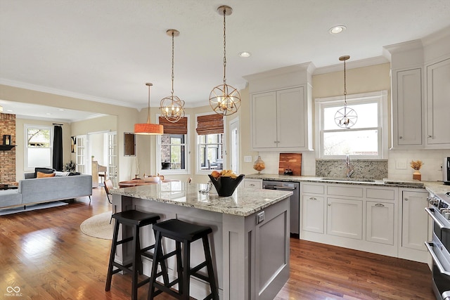 4932 Willow Ridge Ct, Zionsville, IN 46077 - kitchen with open floor plan, a center island, a sink, appliances with stainless steel finishes, and backsplash