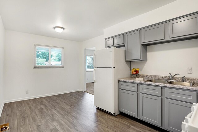 3809 Wildwood Dr, Indianapolis, IN 46239 - kitchen featuring gray cabinets, freestanding refrigerator, a sink, light countertops, and wood finished floors